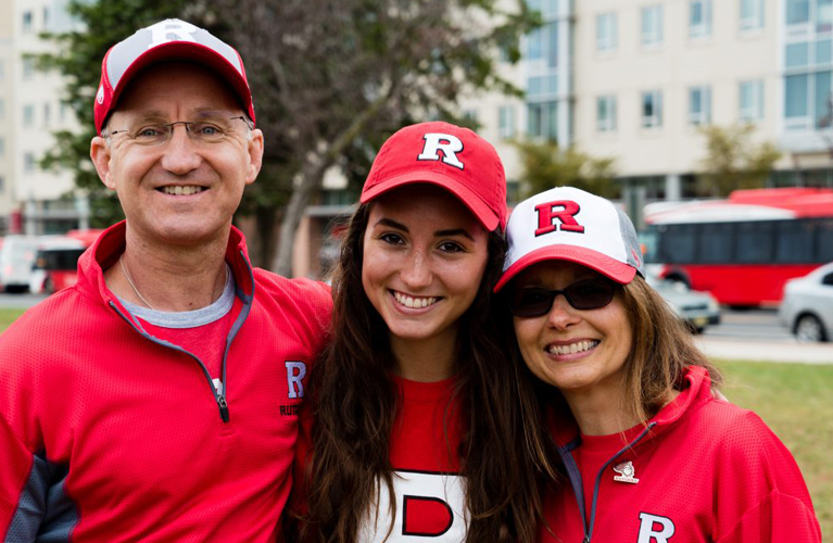 Student hugging two parents